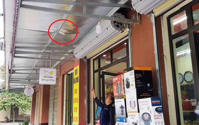 Bà Đặng Thị Hồng chỉ tay vết lõm do bé trai rơi xuống mái tôn